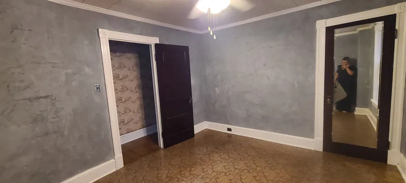 Middle bedroom. Mirrored closet door. Grey walls, white trim. 
