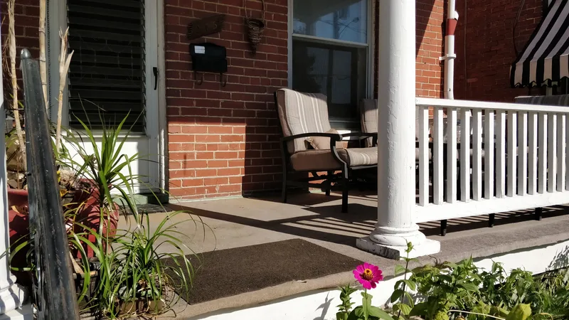 Porch, white trim, chair, plants on the porch